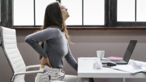 "Woman practicing natural lower back pain treatment through meditation"